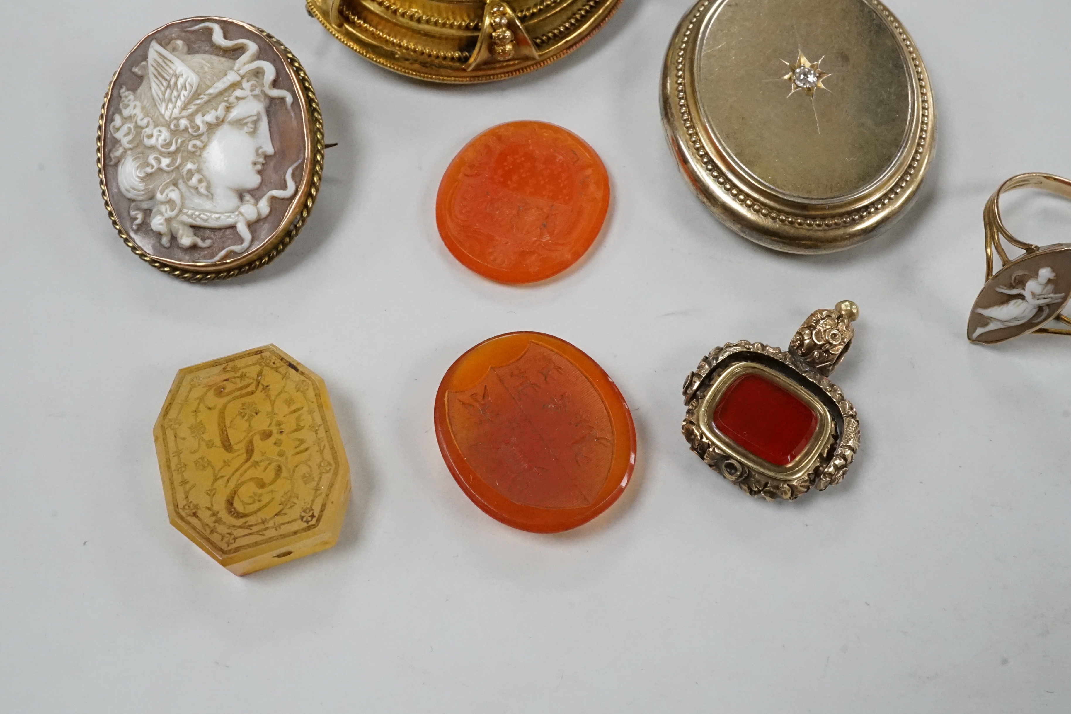 Assorted Victorian jewellery including cameo shell brooch and ring, diamond set locket, brooch, spinning fob seal and three unmounted carnelian intaglios.